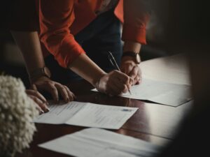 People signing HOA documents