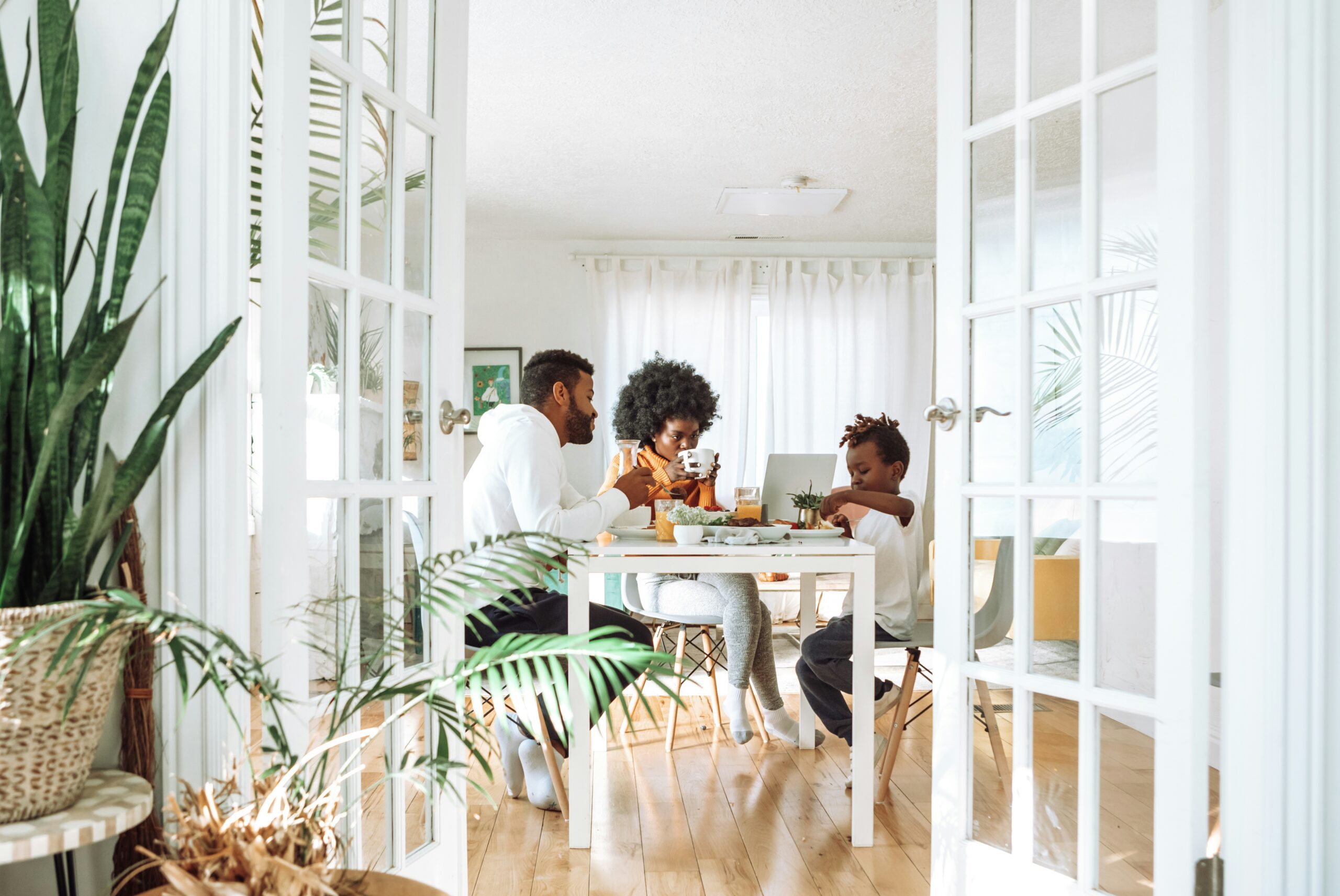 family having breakfast in a bright room