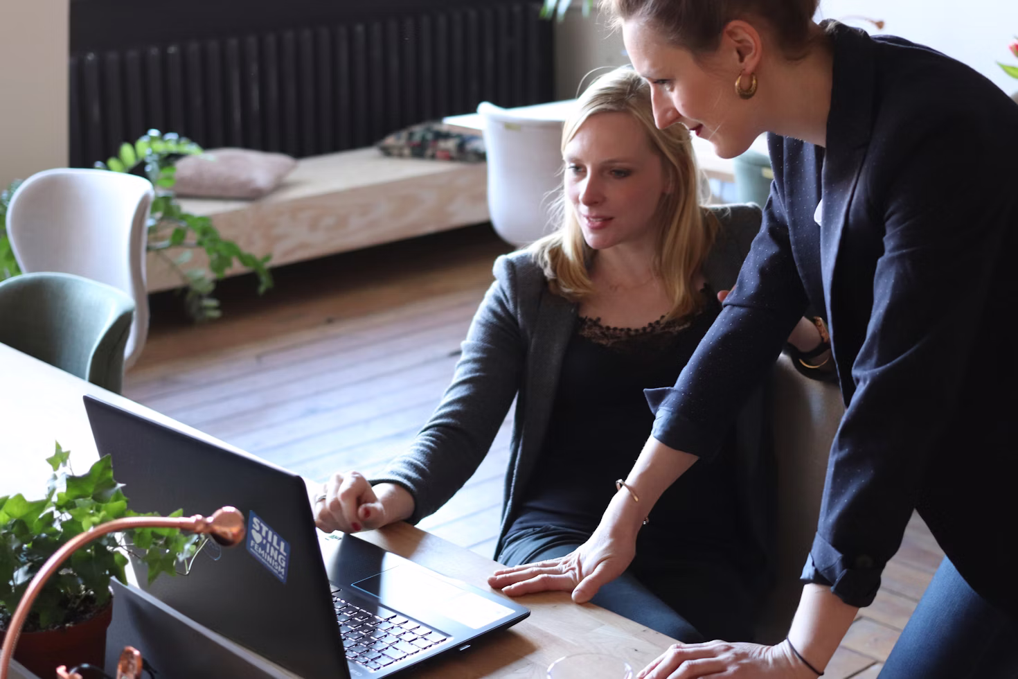 two women working on a laptop