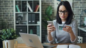 woman making online payment with credit card
